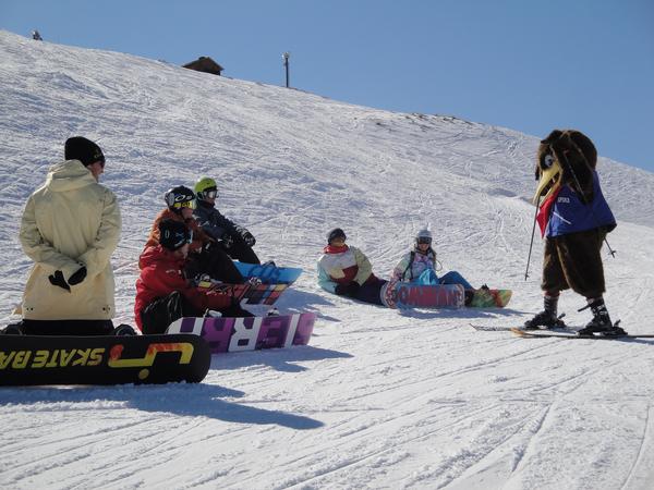 Mascot Spike entertains snowboarders at Coronet Peak, Queenstown, New Zealand